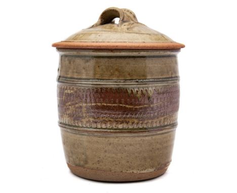 * Richard Batterham [b. 1936] a stoneware jar and cover: of barrel shaped form the cover with lug handle, the body decorated 