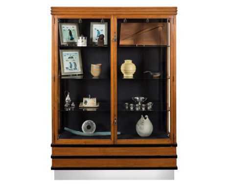 An Art Deco oak, ebonised and chromium display cabinet:, with an angular channelled cornice, fitted with plate glass shelves 