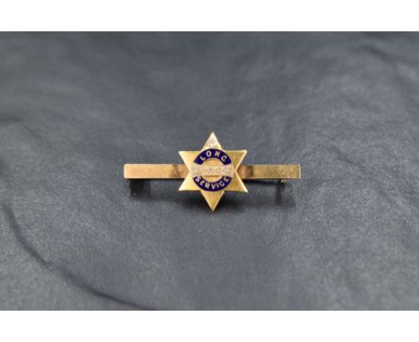 A yellow metal and enamel long service award bar brooch stamped 18ct having inset diamond and inscription en verso dated 1918