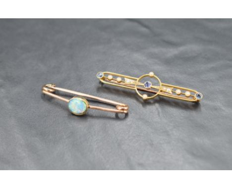 A sapphire and seed pearl bar brooch of openwork design, the three round cut sapphires alternating with seed pearls, marked 1
