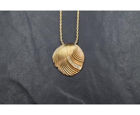 A 1980's Christian Dior diamante set gold plated scallop shell pendant and chain bearing Dior tag, approx 16'