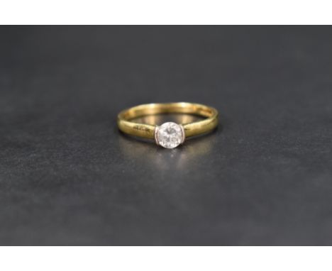 An 18ct gold diamond solitaire ring, the central round brilliant cut diamond measuring approximately 0.50ct, set in a claw an