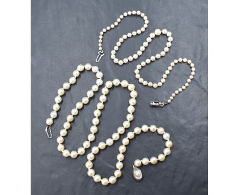 Two strings of cultured pearls comprising a graduated string having a pinkish-white lustre with a silver marcasite set bow cl