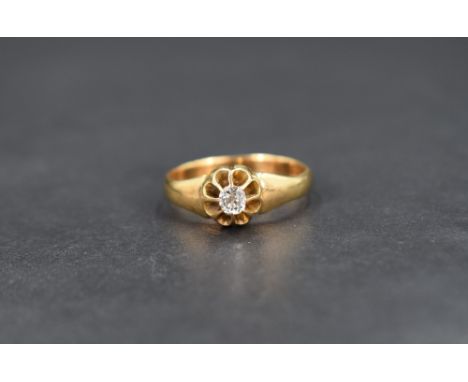 A diamond solitaire gypsy style ring, the mixed cut diamond measuring approximately 0.20cts, on a yellow metal shank with a r