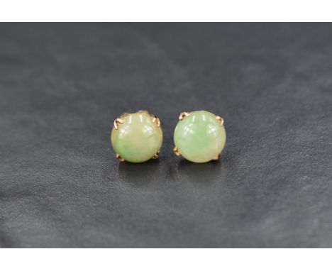 A pair of 9ct gold jade stud earrings, the jade cabochons in a four prong setting, 3g