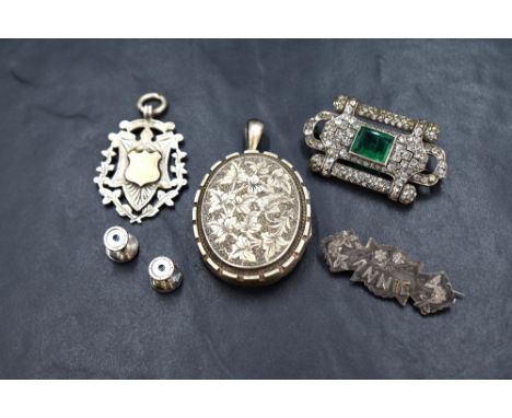 A small group of silver and white metal jewellery comprising a silver shield medal pendant, a silver bar brooch marked 'ANNIE