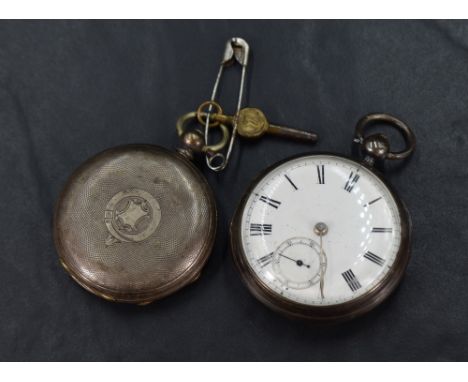 A Victorian silver open face key wound pocket watch, the white dial having Roman numerals and subsidiary dial, with engine tu