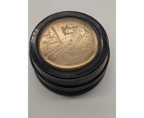 A Japanese snuff box with white metal mounted etched with erotic scenes, D.8cm