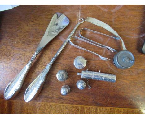 A collection of silver items, to include a button hock, show horn, bobbin case, patch box thimbles etc