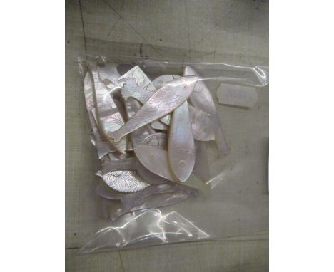 A collection of mother of pearl counters many formed as stylized fish&nbsp;
