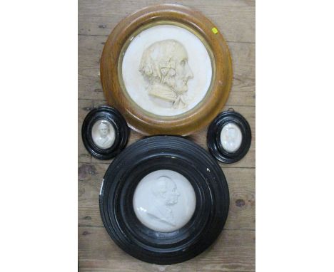 Four plaster relief portrait plaques, all framed