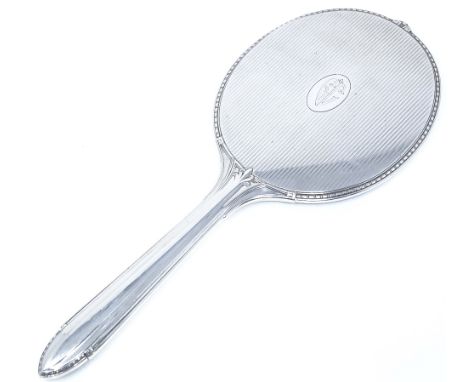 A large sterling silver dressing table hand mirror, with gadrooned border and engine turned decoration, length 33cm 