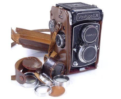 A Yashica LM camera, serial no. 124770, original leather case with additional lenses 