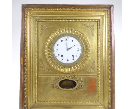 An early 19th century Austrian cabinet clock, enamelled dial in textured brass bezel, mounted in giltwood surround and glazed