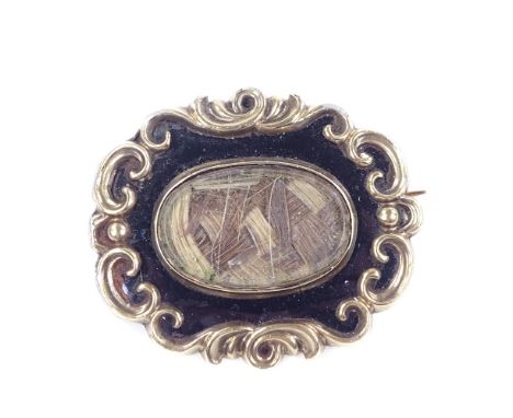 A Victorian unmarked yellow metal black enamel and woven hair panel mourning ring, with foliate border, brooch length 39.7mm,