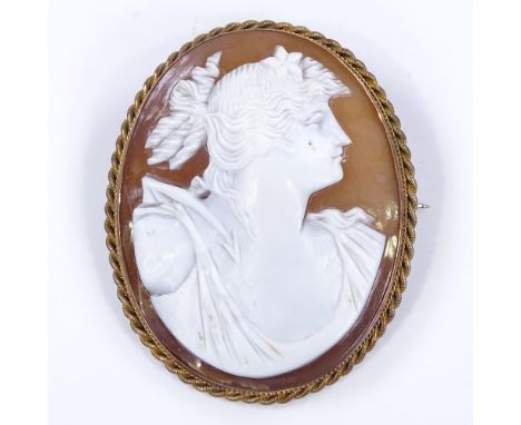 A relief carved cameo shell panel brooch/pendant, depicting Classical female portrait, in 9ct gold rope twist frame, brooch h