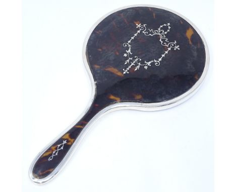 A tortoiseshell and silver pique inlaid dressing table hand mirror, indistinct maker's marks, hallmarks London 1923, length 2