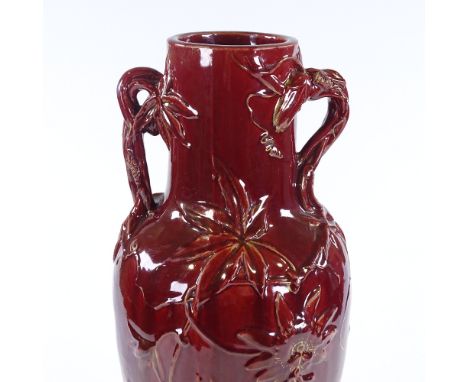 A Claymout Massier red glaze ceramic 2-handled vase, with relief moulded designs, height 50cm 