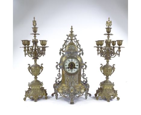 An ornate 19th century cast brass-cased clock garniture, enamel dial signed Richond of Montmartre, together with a pair of ma