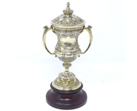 A small silver-gilt lidded 2-handled trophy, on turned wood stand, by Mappin &amp; Webb, hallmarks Sheffield 1939, trophy hei