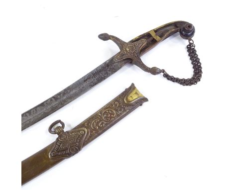 A 19th century Indian curved sword with etched blade, gilt-brass and horn-mounted handle (one horn grip missing), in original