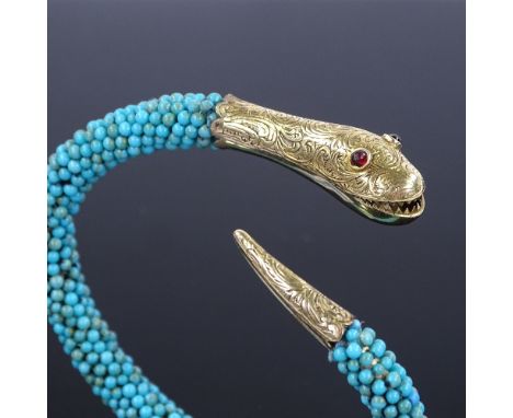 A Victorian turquoise and garnet snake bangle, with unmarked 15ct gold head and tail mounts, with engraved scrollwork decorat