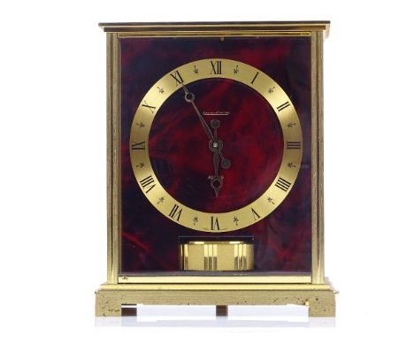 A Jaeger LeCoultre Embassy Atmos clock, with red lacquer simulated tortoiseshell dial, case height 22cm, working order 