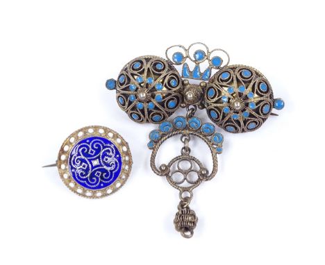 A Norwegian silver-gilt blue enamel filigree brooch, height 52.9mm, and a similar silver-gilt blue and white enamel brooch, b