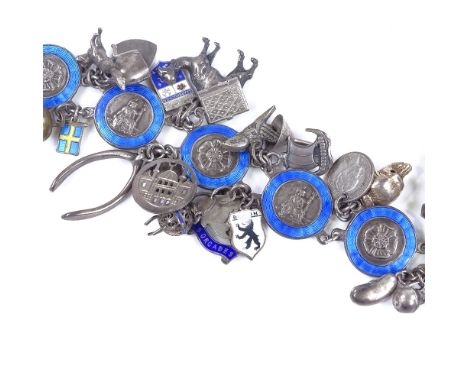 A George VI silver and blue enamel charm bracelet, including numerous various charms, maker's marks W and S, hallmarks London