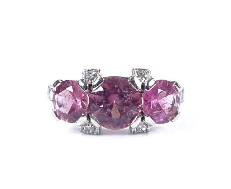 An unmarked white gold pink tourmaline and diamond dress ring, with diamond set shoulders, settings test as 18ct, setting hei
