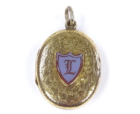 A Victorian 9ct gold locket pendant, with intaglio carved shield-shaped sardonyx seal, within a floral and lattice engraved s