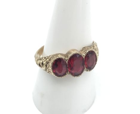 A Victorian ornate ladies gold ring set with 3 large ruby stones, Ring size P, Largest measures 8x5.5mm 