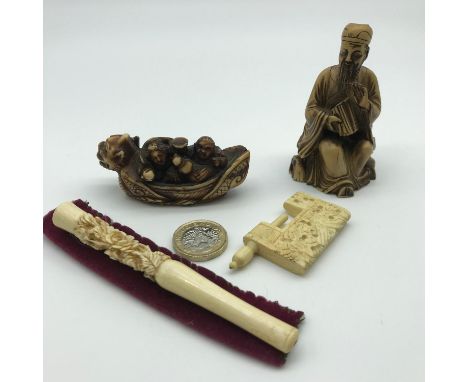 An Ivory carved Chinese floral design cheroot, Netsuke figure depicting Drunk Japanese fisher men, Chinese Scholar figure and