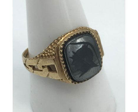 A Gents 9ct gold signet ring set with a black onyx stone engraved with a Roman head. Ring size S 1/2, Weighs 4.25grams 