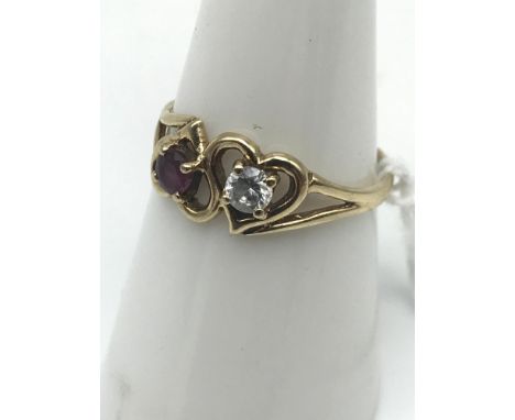 A Ladies 9ct gold cz &amp; purple stone ring 