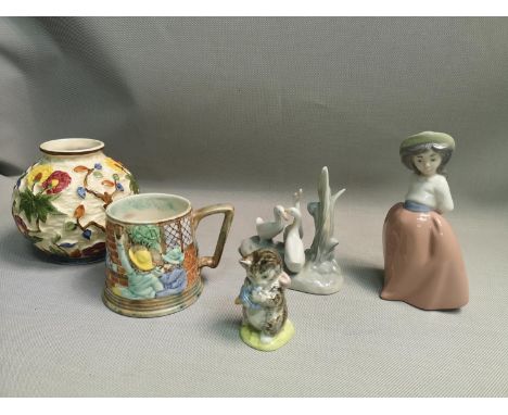 A mixed lot of collectable porcelain to include; Beatrix Potter 'Miss Moppet' Figurine, Nao figurines, Burslem mug &amp; Indi