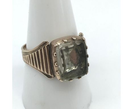 A Victorian gents gold ring set with a large clear stone, Ring size S. Weighs 4.62grams 