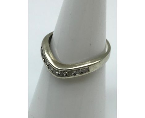 A Ladies white gold eternity ring set with .25ct of diamonds, ring size M. Weighs 1.82grams (Gold marks are rubbed) 