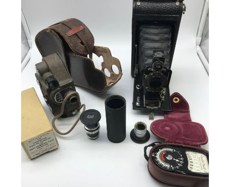 A Selection of vintage camera items includes Revere cine camera with case, Steinheil Munchen Cassar lens set &amp; Kodak bell