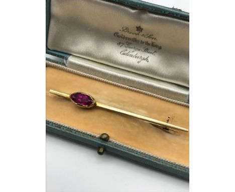 An Antique solid gold and large ruby stone brooch, Ruby measures 10.5x4.8mm, Possibly high grade gold, Comes with box 'Brook 