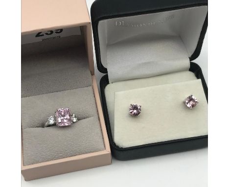 A Silver ladies ring set with large pink and two clear stones together with a pair of silver and pink stone earrings. 