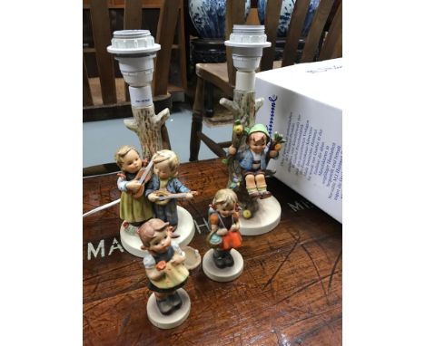 A Selection of Goebel Hummel Figurines, Included in the lot is two table lamps &amp; two girl figures. 