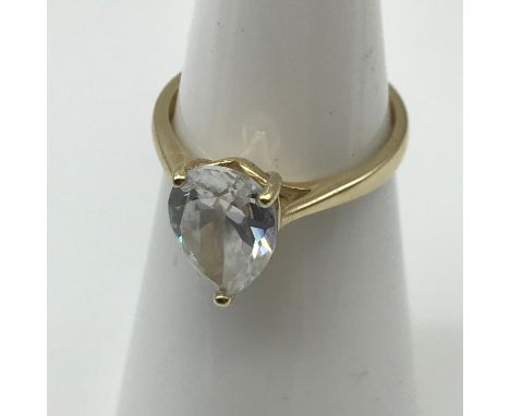 A 9ct gold ladies ring set with a large CZ tear drop stone. Ring size I 