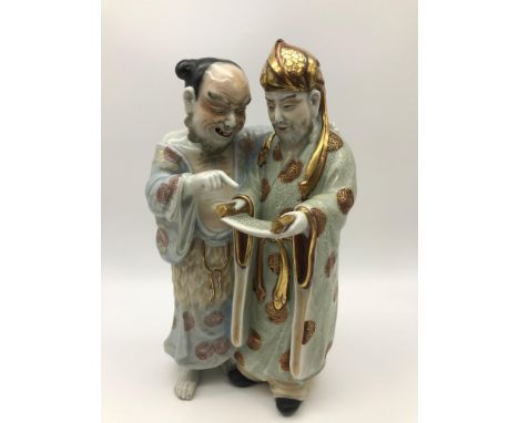 An 18th/19th century Chinese porcelain double figure, Highly detailed painted figures of two men reading from a scroll, Hand 