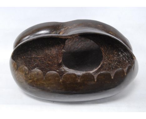 Coco de Mer nut carved in the form of a basket, first part of 20th century, origin Seychelles, approximately 31cm long. 