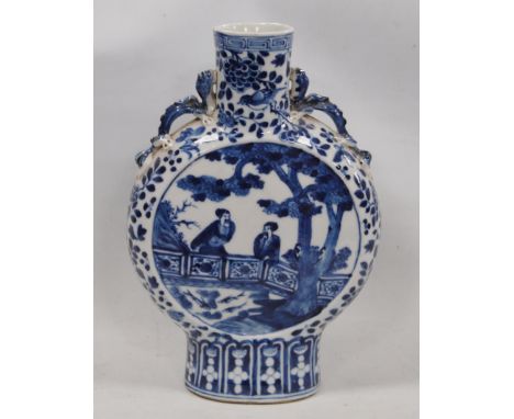 Chinese blue and white Kangxi-style flask with central panel bearing figures in a garden scene in all over foliage, 26cm high