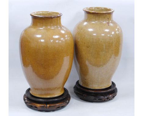 Pair of Chinese Qianlong revival earthenware vases, crackle glazed in muted colours, 31cm high, on hardwood stands.  (2)CONDI