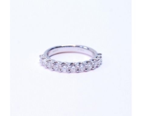 Diamond half eternity ring with eleven brilliants, each approximately .10ct, in platinum, size M. 