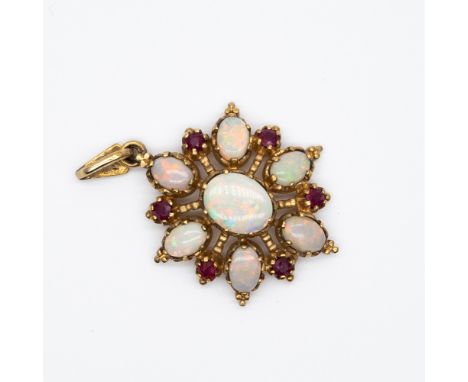 A 9ct yellow gold opal and ruby pendant,
opals are firey to the eye,
36mm x 24mm wide,
largest opal is 9mm x 6mm,
4.6 grams i