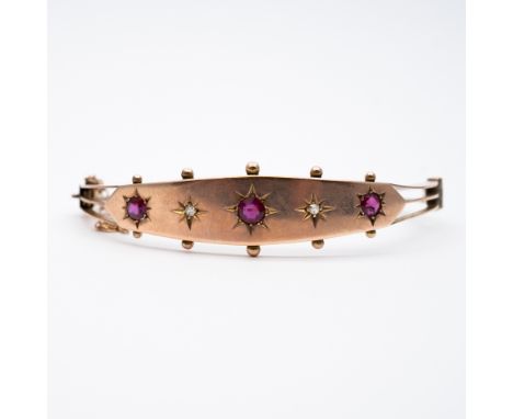 A 9ct yellow gold victorian ruby and diamond bangle,
12mm at widest part x 2.5mm at narrowist,
set with ruby and diamond,
7.8